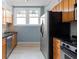 Well-lit kitchen featuring stainless steel appliances, granite countertops, and blue-grey painted walls at 677 Somerset Ne Ter # C6, Atlanta, GA 30306