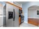 Functional kitchen with stainless steel refrigerator and gas range, complemented by wooden cabinets at 677 Somerset Ne Ter # C6, Atlanta, GA 30306