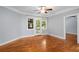 Bright living room featuring hardwood floors, a ceiling fan, and large windows bringing in natural light at 677 Somerset Ne Ter # C6, Atlanta, GA 30306