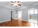 Spacious living area featuring hardwood floors, ceiling fan, and an open doorway to the kitchen at 677 Somerset Ne Ter # C6, Atlanta, GA 30306