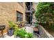 Brick building with a private patio and lush landscaping at 677 Somerset Ne Ter # C6, Atlanta, GA 30306