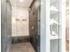 Modern bathroom featuring a glass-enclosed shower with stylish tile work and a built-in shelf for toiletries at 911 Lenox Hill Ne Ct, Atlanta, GA 30324