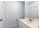 Bathroom featuring a white vanity with ample storage, large mirror, and a toilet at 911 Lenox Hill Ne Ct, Atlanta, GA 30324