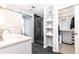 Sleek bathroom with glass enclosed shower, closet, and shelving for storage at 911 Lenox Hill Ne Ct, Atlanta, GA 30324