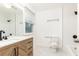 Updated bathroom with wood vanity, marble top, decorative mirror and modern fixtures, tub and a glass shower at 911 Lenox Hill Ne Ct, Atlanta, GA 30324