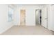 Comfortable bedroom featuring neutral carpet, white walls, and access to bathroom and closet at 911 Lenox Hill Ne Ct, Atlanta, GA 30324