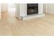 Cozy fireplace set against a neutral backdrop with light hardwood floors at 911 Lenox Hill Ne Ct, Atlanta, GA 30324