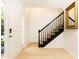 Clean foyer with a staircase, light wood flooring, and a decorative mirror at 911 Lenox Hill Ne Ct, Atlanta, GA 30324