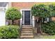 Inviting front entrance with brick steps, a sleek black door, and neatly trimmed landscaping at 911 Lenox Hill Ne Ct, Atlanta, GA 30324