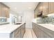 Kitchen island with white countertops and sink, stainless steel appliances, grey cabinets, and mosaic backsplash at 911 Lenox Hill Ne Ct, Atlanta, GA 30324