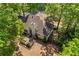 A beautiful aerial view of a home surrounded by lush trees and featuring a spacious outdoor deck for relaxation at 115 Stonewall Dr, Covington, GA 30016
