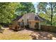 Home's backyard featuring a wood deck with space for dining and a private wooded area at 115 Stonewall Dr, Covington, GA 30016