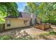 Features home's backyard with a wooden deck perfect for outdoor enjoyment and relaxation amid lush greenery at 115 Stonewall Dr, Covington, GA 30016