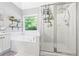 This bathroom showcases a tub and glass door shower combination with neutral tile work at 115 Stonewall Dr, Covington, GA 30016