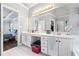 Bright bathroom with a double sink vanity, a tub, and a view of the main bedroom at 115 Stonewall Dr, Covington, GA 30016