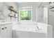 This bathroom showcases a tub and glass door shower combination with neutral tile work at 115 Stonewall Dr, Covington, GA 30016