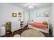 A cozy bedroom featuring wood floors, dresser, and a comfy bed at 115 Stonewall Dr, Covington, GA 30016