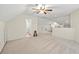 Carpeted bonus room provides access to a bathroom, storage and space at 115 Stonewall Dr, Covington, GA 30016