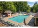 Features a sparkling community pool surrounded by chairs and lush landscaping, perfect for relaxation and leisure activities at 115 Stonewall Dr, Covington, GA 30016