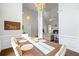 Dining area with hardwood floors, chandelier, table with six chairs and view to living room at 115 Stonewall Dr, Covington, GA 30016
