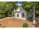 A well-maintained home featuring stucco siding, arched windows, and mature trees at 115 Stonewall Dr, Covington, GA 30016