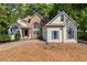 Charming home featuring stone accents, lush landscaping, and a welcoming front entrance at 115 Stonewall Dr, Covington, GA 30016