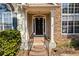 Inviting front entrance with stone accents, a covered porch, and a stylish front door at 115 Stonewall Dr, Covington, GA 30016
