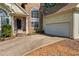 Front exterior showcasing stone details, a two-car garage, and a paved driveway at 115 Stonewall Dr, Covington, GA 30016