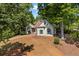 Beautiful home nestled among mature trees with a curved driveway and a well-kept lawn at 115 Stonewall Dr, Covington, GA 30016