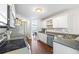 Bright kitchen with white cabinets and stainless steel appliances at 115 Stonewall Dr, Covington, GA 30016