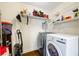 Functional laundry area with modern washer and dryer and wire shelving at 115 Stonewall Dr, Covington, GA 30016
