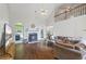 Spacious living room with vaulted ceilings, fireplace, and large windows at 115 Stonewall Dr, Covington, GA 30016