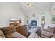 Cozy living room features a vaulted ceiling, fireplace, wood floors, and comfortable furnishings at 115 Stonewall Dr, Covington, GA 30016
