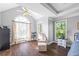 Vaulted Primary bedroom features a sitting area, hardwood floors, and natural lighting at 115 Stonewall Dr, Covington, GA 30016