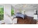 Large main bedroom features wood flooring, sitting area, and decorative ceiling at 115 Stonewall Dr, Covington, GA 30016