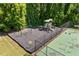 A tennis court with a charming playground nearby for entertainment and recreation in a serene setting at 115 Stonewall Dr, Covington, GA 30016