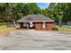 View of the community pool house, built of brick and located behind a fence at 115 Stonewall Dr, Covington, GA 30016