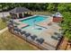 Community pool area featuring a splash fountain, seating, and a small brick building at 115 Stonewall Dr, Covington, GA 30016