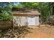 Exterior of the beige-colored storage shed with double doors and a small yard to the rear of the home at 115 Stonewall Dr, Covington, GA 30016