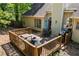 A backyard deck featuring outdoor furniture, a grill, and an umbrella for relaxing or entertaining in the outdoor space at 115 Stonewall Dr, Covington, GA 30016