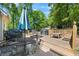 Features a wooden deck with tables, chairs, umbrellas and a grill, ideal for outdoor entertaining and relaxation at 115 Stonewall Dr, Covington, GA 30016