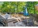 A backyard area offering a wooden deck with a covered grill, seating, and an umbrella for outdoor leisure and enjoyment at 115 Stonewall Dr, Covington, GA 30016