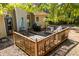 An inviting wooden deck with a grill, seating, and umbrella, perfect for outdoor dining and entertaining in a backyard at 115 Stonewall Dr, Covington, GA 30016
