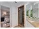 Bright bathroom featuring a tiled shower, double vanity with marble countertop and access to the main bedroom at 1325 Peachtree Ne St # 401, Atlanta, GA 30309