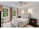 Bedroom with plush rug, ceiling fan and large windows providing ample natural light at 1325 Peachtree Ne St # 401, Atlanta, GA 30309