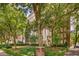 Elegant brick apartment building with meticulously landscaped grounds and mature trees showcasing timeless architecture at 1325 Peachtree Ne St # 401, Atlanta, GA 30309