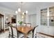 Dining room featuring built-in shelving, classic light fixture, and seating for six at 1325 Peachtree Ne St # 401, Atlanta, GA 30309