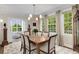 Elegant dining room with large windows, classic light fixture, and seating for six at 1325 Peachtree Ne St # 401, Atlanta, GA 30309