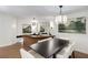 Open dining room with a large table, pendant lighting, modern art and adjacent wet bar at 1325 Peachtree Ne St # 401, Atlanta, GA 30309