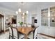 Dining room adjacent to kitchen, featuring built-in shelving, classic light fixture, and seating for six at 1325 Peachtree Ne St # 401, Atlanta, GA 30309